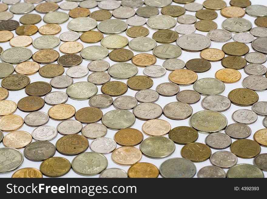 Field of coins on white background, focus on center of image