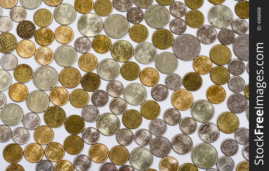 Field of coins on white background, view from above