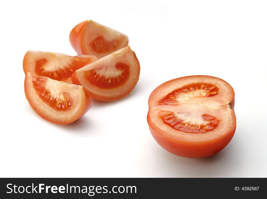 Cut sunny tomato on white (with path). Cut sunny tomato on white (with path)