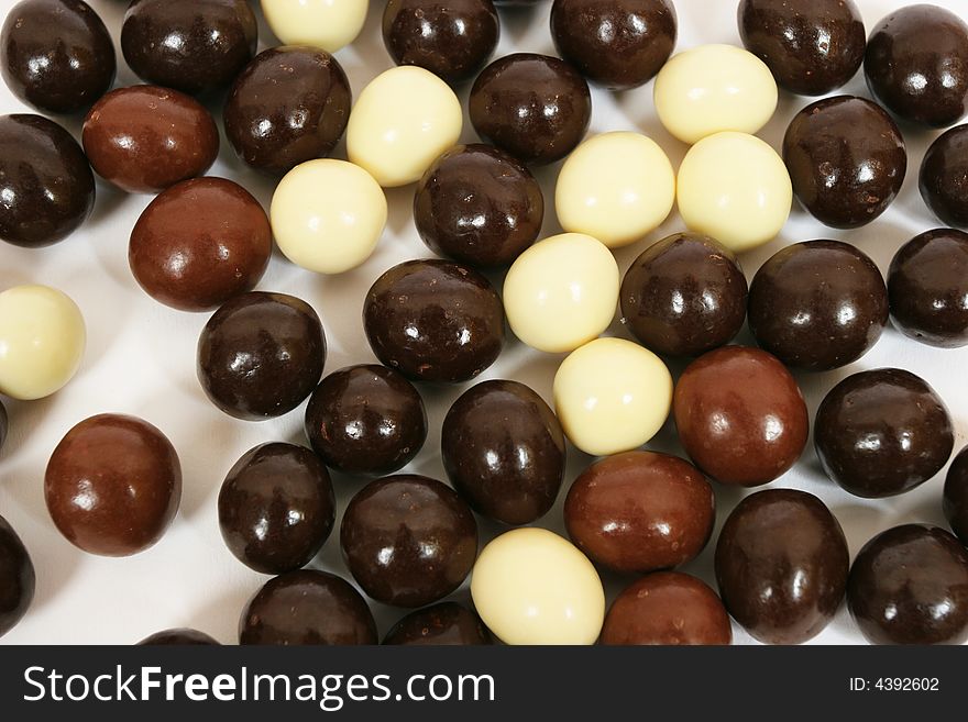 Three different types of chocolate candies. Abstract background