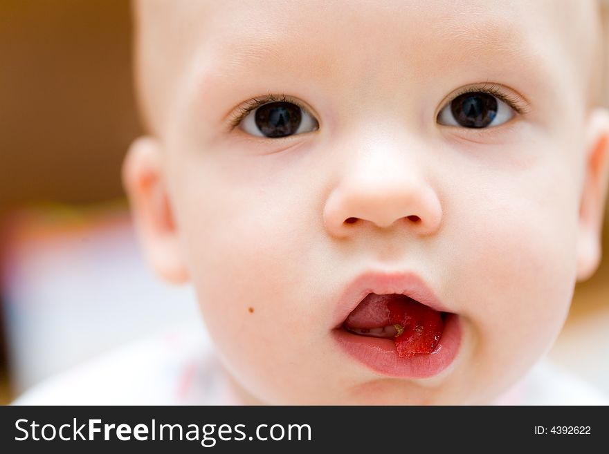 Baby eating apple. Children's face close-up