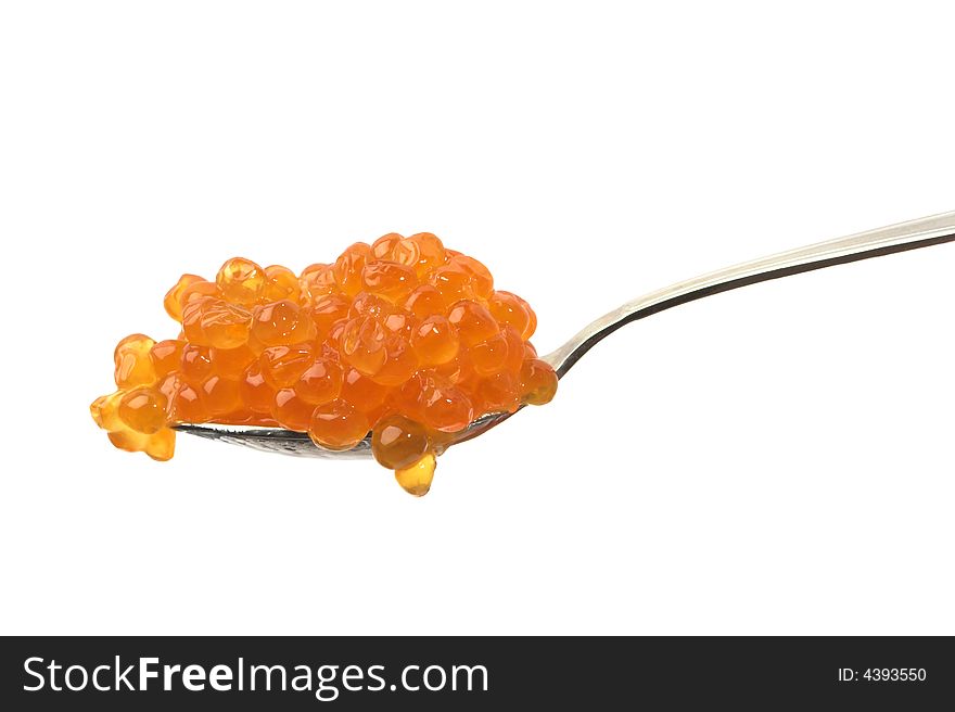 Red caviar on a spoon, isolated on white.