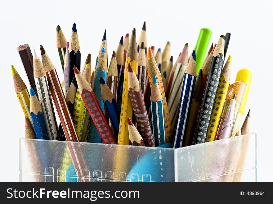 Coloured pencils in a clear plastic pencil holder