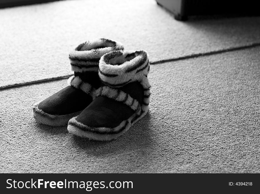 Child's fluffy slippers in monochrome. Child's fluffy slippers in monochrome