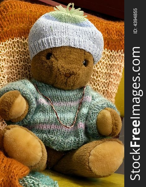 Macro of a Brown Teddy Bear in Winter sweater and hat. Macro of a Brown Teddy Bear in Winter sweater and hat