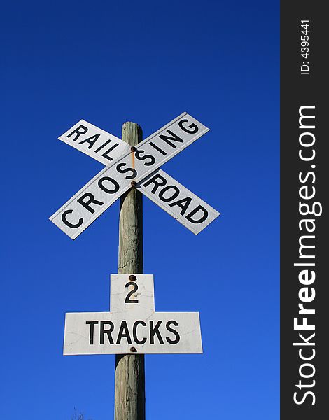 Railroad Crossing sign against a blue sky. Railroad Crossing sign against a blue sky