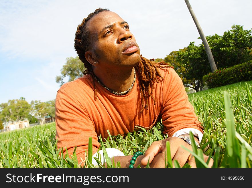 Man lying on the grass shot from grass level. Man lying on the grass shot from grass level.