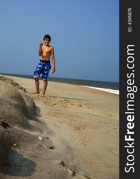 Boy Standing On Beach