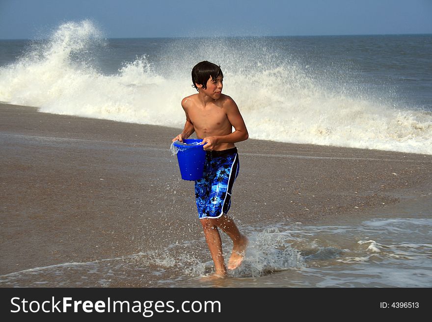 Boy with pail on beach. Boy with pail on beach