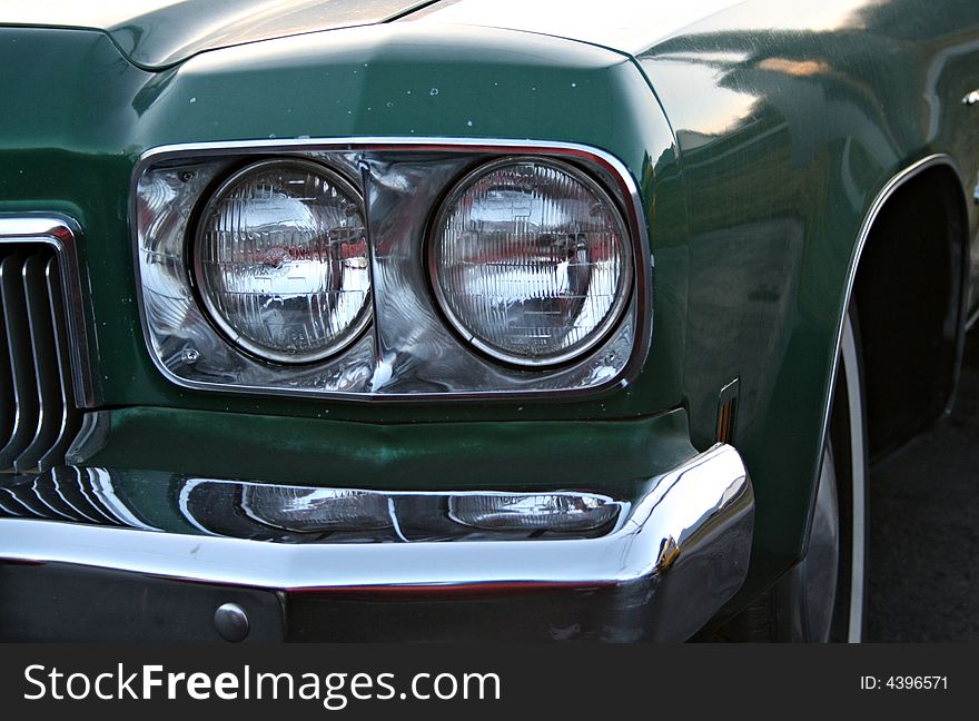 The double round headlights of a vintage car. The double round headlights of a vintage car.