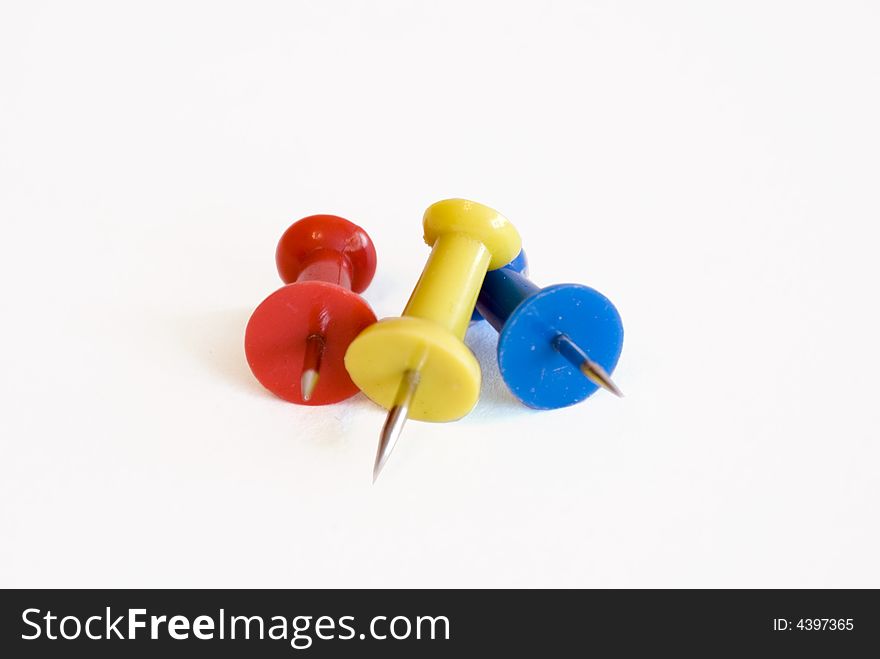 Stationary pins of three colors isolated on white background. Stationary pins of three colors isolated on white background