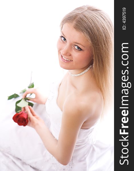 Young smiling bride with rose