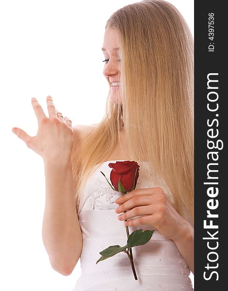 Young smiling bride with red rose look to ring on hand