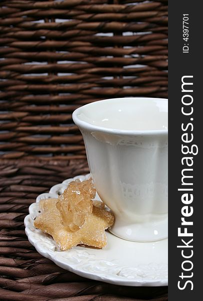 Cup and saucer with star shaped biscuits. Cup and saucer with star shaped biscuits