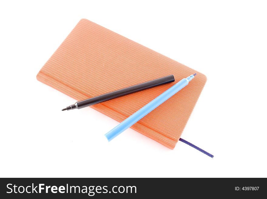 Red book and markers isolated on a white background