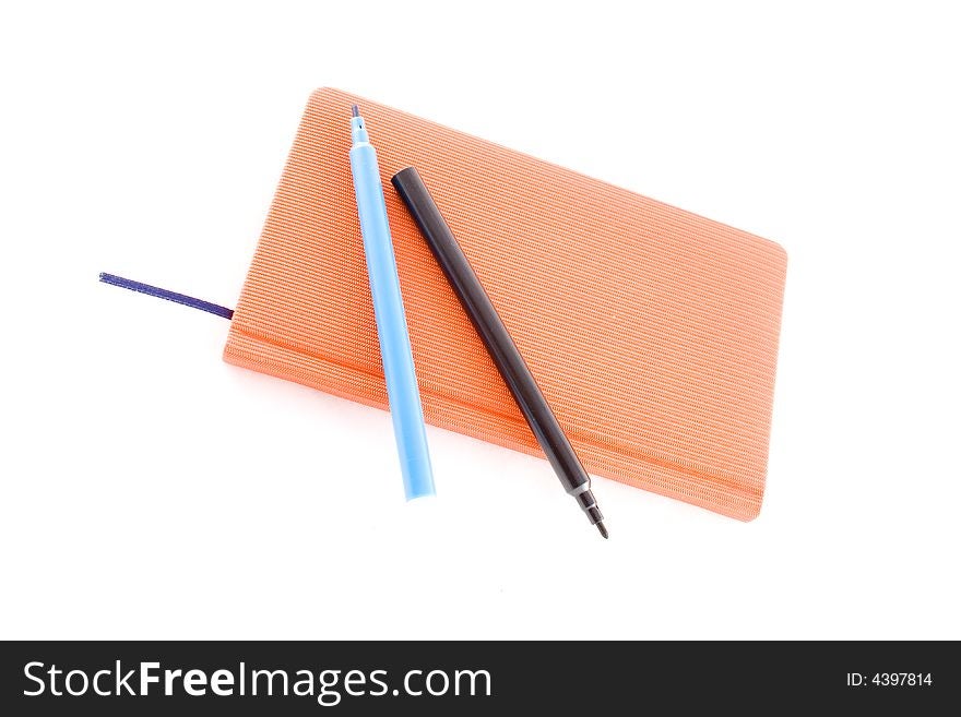 Red book and markers isolated on a white background