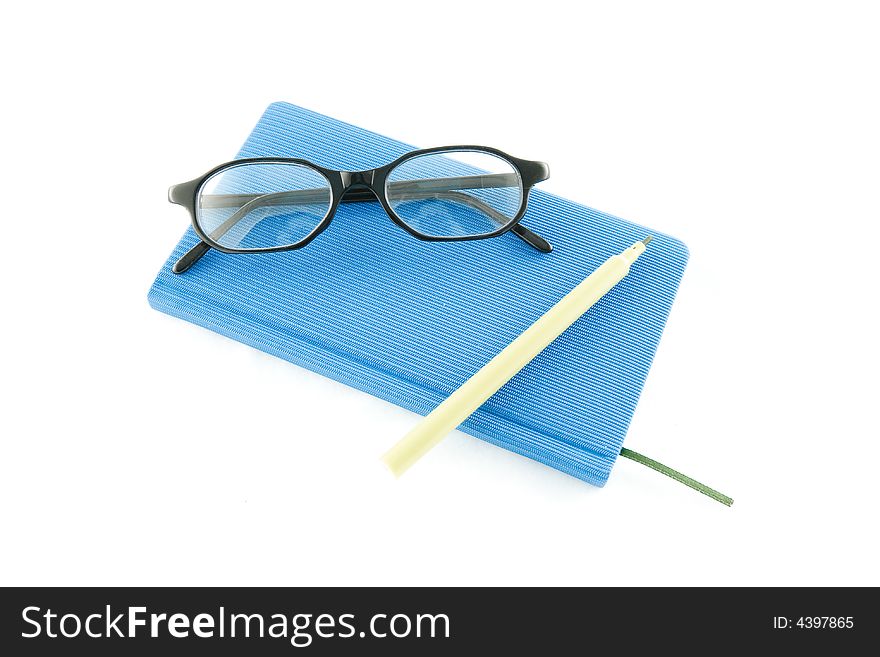 Blue book, black glasses and marker on a white background. Blue book, black glasses and marker on a white background