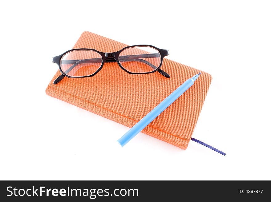 Red book, black glasses and marker isolated on a white background