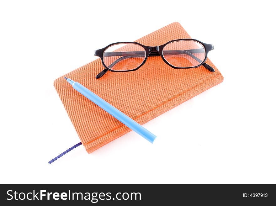 Red book, black glasses and markers isolated on a white background