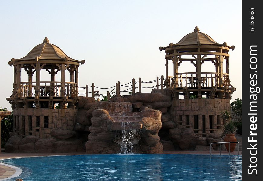 Brown oriental towers from red sea, in daylight, with a swimming pool and a little waterfall. Brown oriental towers from red sea, in daylight, with a swimming pool and a little waterfall