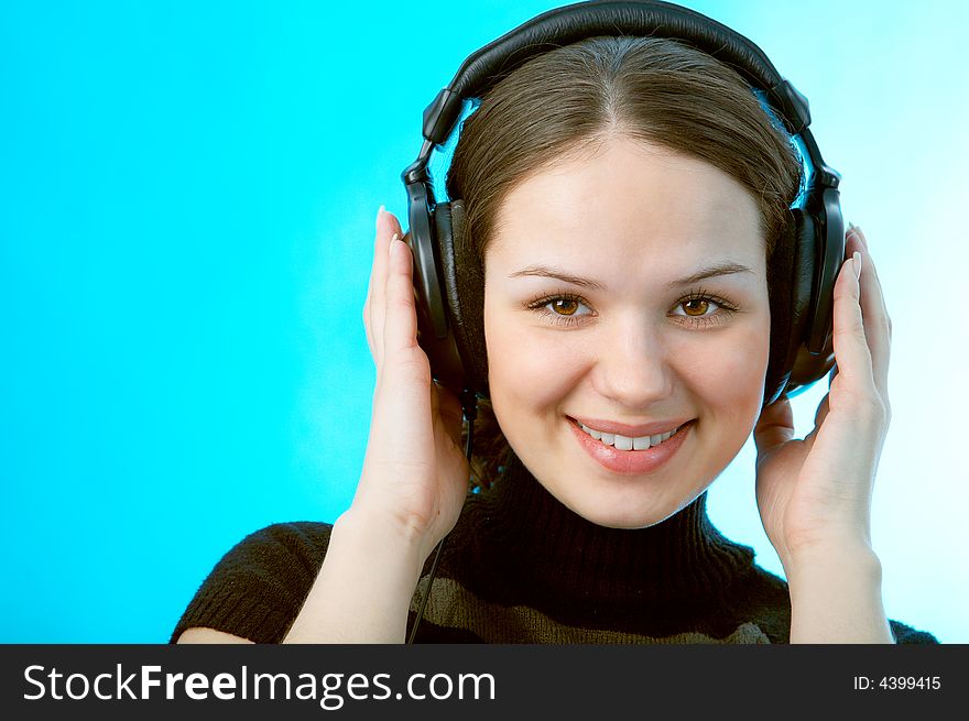 Woman with head phones on blue background