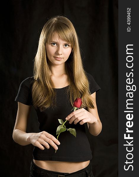 Portrait of young woman with red rose