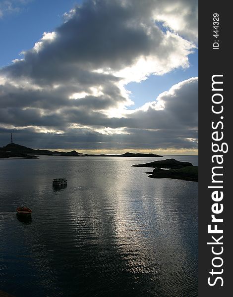 In Aa, Lofoten, northern Norway , the view from the seahouse. The sun was hiding, but the light was streaming through the sky, making the sea look like silver.Behind the sky there's always sunshine. In Aa, Lofoten, northern Norway , the view from the seahouse. The sun was hiding, but the light was streaming through the sky, making the sea look like silver.Behind the sky there's always sunshine...