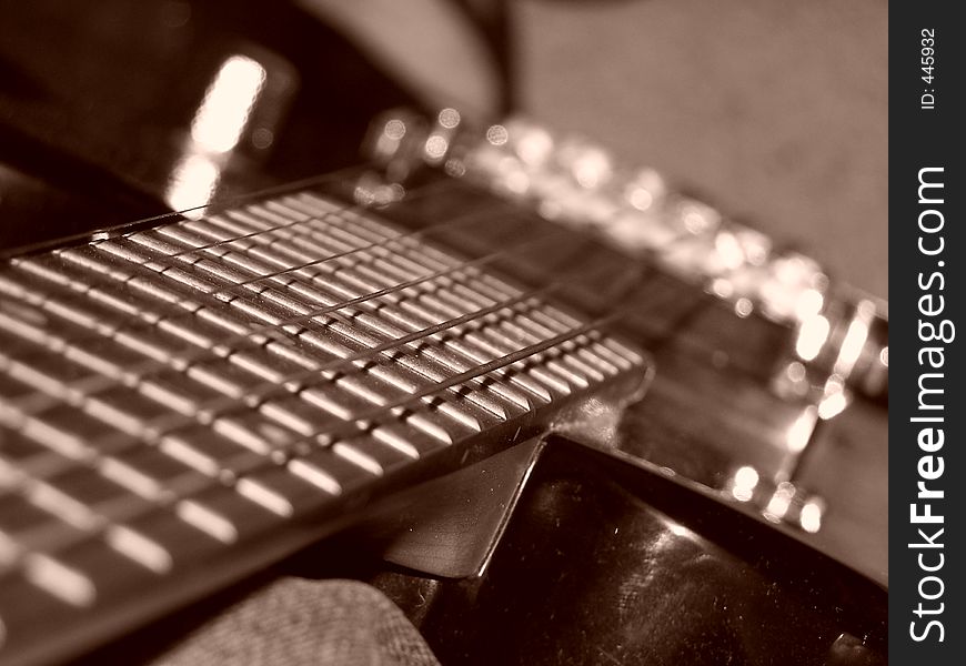 A black BC Rich Warlock electric guitar. Upclose, looking down the strings. A black BC Rich Warlock electric guitar. Upclose, looking down the strings.