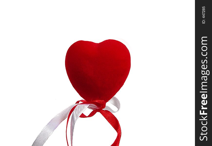 Red heart and ribbon over white