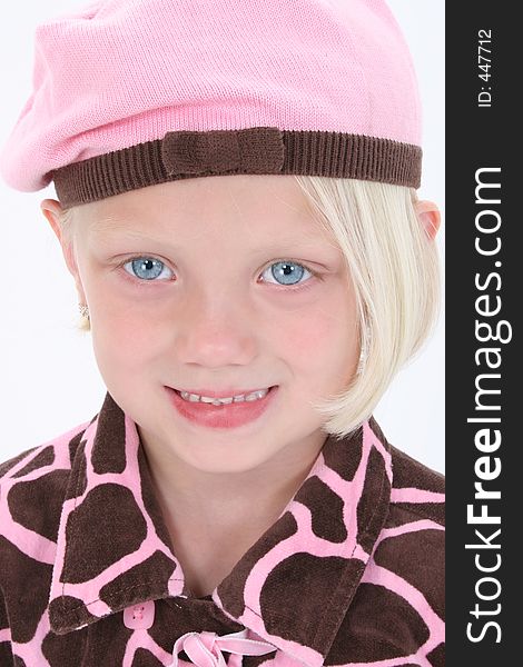 Adorable girl in pink barret with blonde hair and big blue eyes.