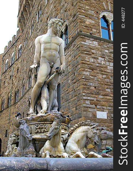 Closeup of classical Roman statue of nude man surrounded by horses.