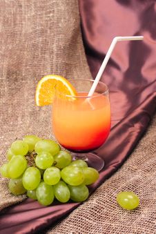 Cocktail Of Orange Juice With A Grape Branch Royalty Free Stock Photos Cocktail Of Orange Juice With A Grape Branch Royalty Free Stock Photos
