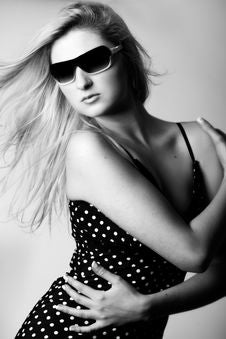 Girl With Sunglasses Looking Down Stock Image