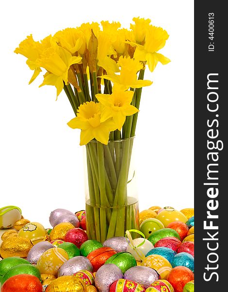 Daffodils in vase with many easter eggs taken on a clean white background. Daffodils in vase with many easter eggs taken on a clean white background.