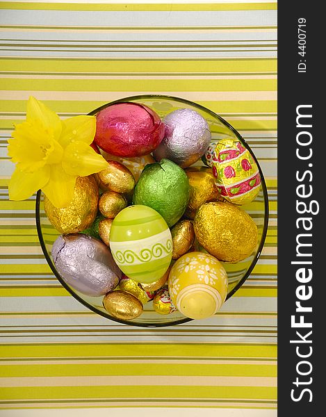 Easter eggs and flower in bowl.