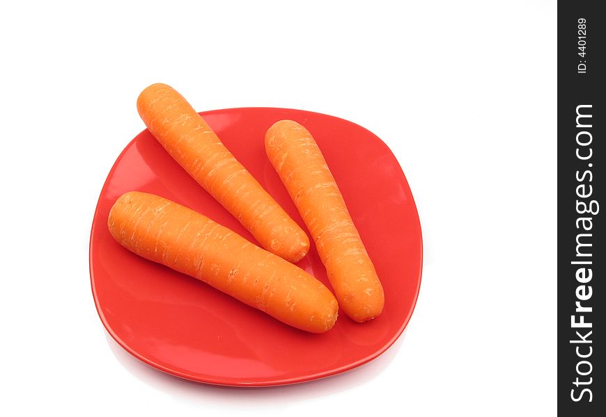 Fresh carrot on red dish. Fresh carrot on red dish