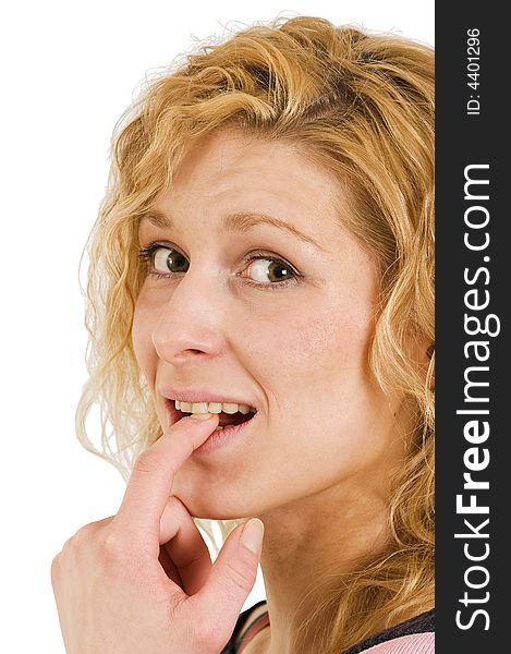 Young blond woman in thinking gesture and between teeth; lateral view; close up. Young blond woman in thinking gesture and between teeth; lateral view; close up