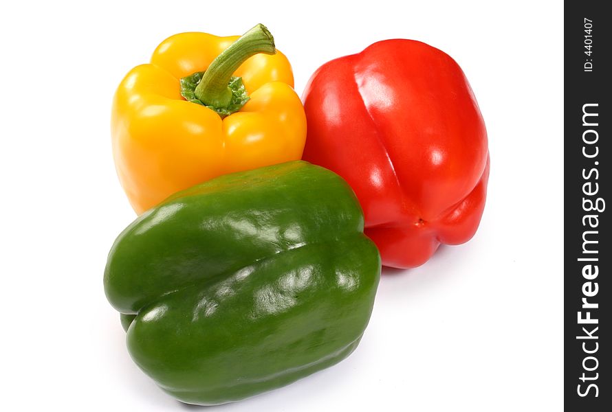 Red, yellow and green paprika on white background
