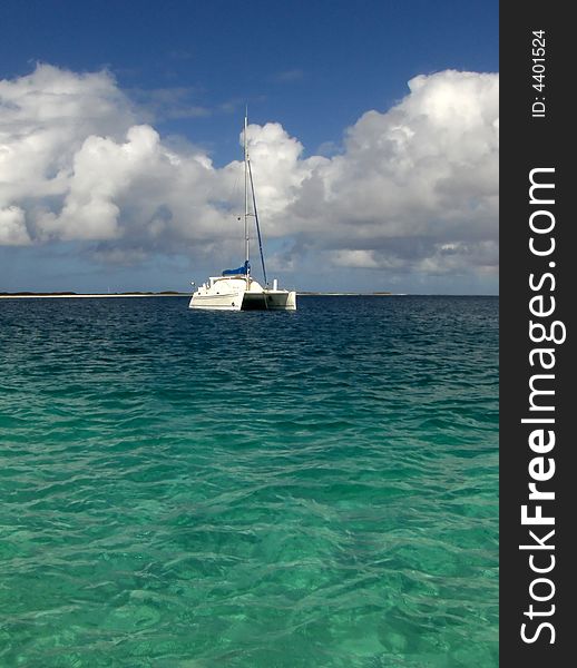 White luxury catamaran boat over blue and green sea
