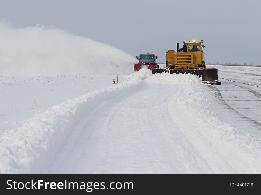 Snow-removing technics behind work. Snow-removing technics behind work