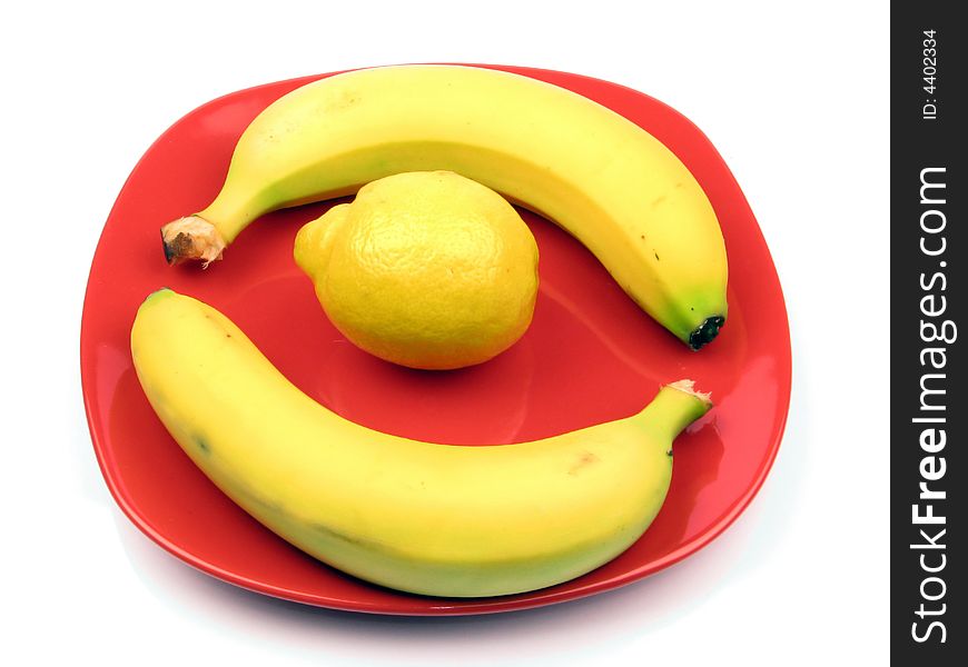 Yellow fruits on a red plate. Yellow fruits on a red plate