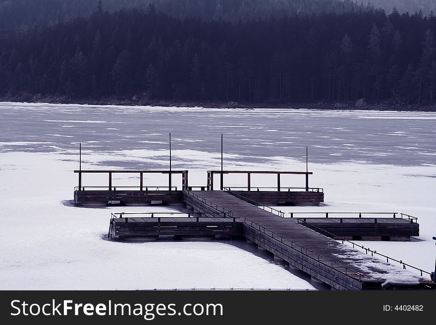 Frozen lake beetwen wood in Bavaria