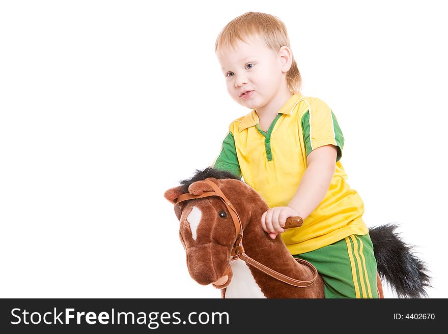 A small boy on a toy horse