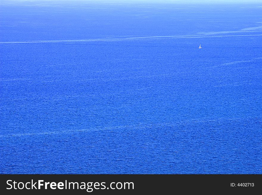 A White Sailboat On The Blue Water