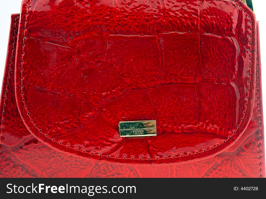 Red leather wallet with golden plate macro shot