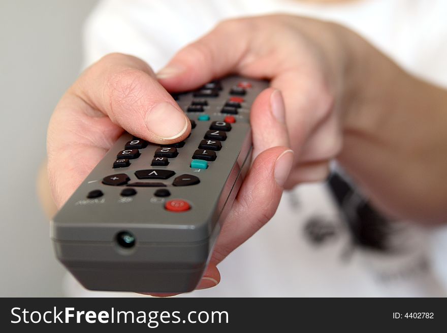 Changing channels on TV using remote control. Changing channels on TV using remote control