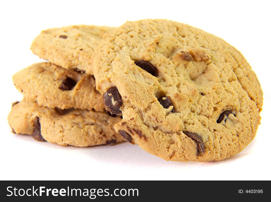 A pile of crunchy choc-chip cookies on a white background. A pile of crunchy choc-chip cookies on a white background..
