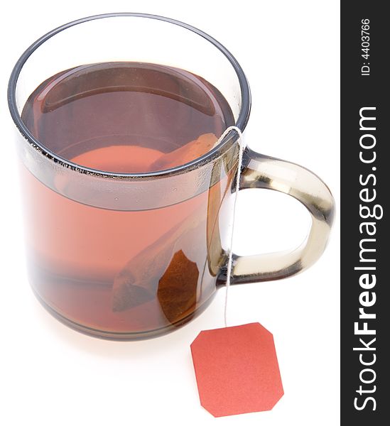 Glass teacup with  tea bag on white background