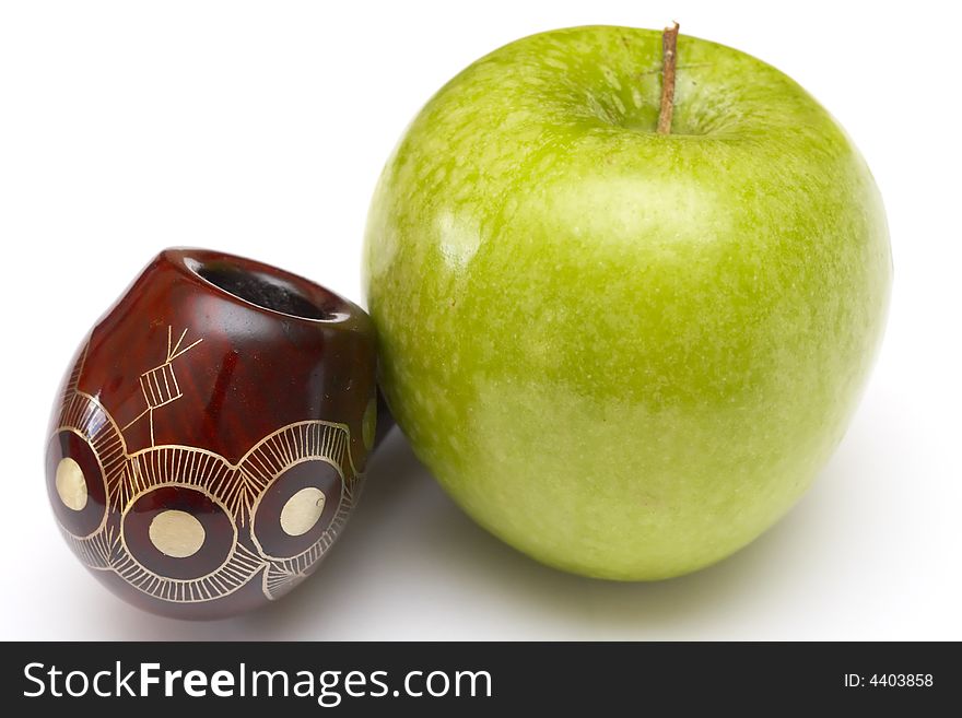 Long ornamented north-caucasian pipe with big green apple at white background. Long ornamented north-caucasian pipe with big green apple at white background