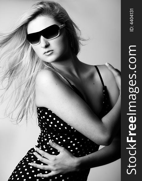 Beautiful girl with a pair off sunglasses in the studio. Beautiful girl with a pair off sunglasses in the studio